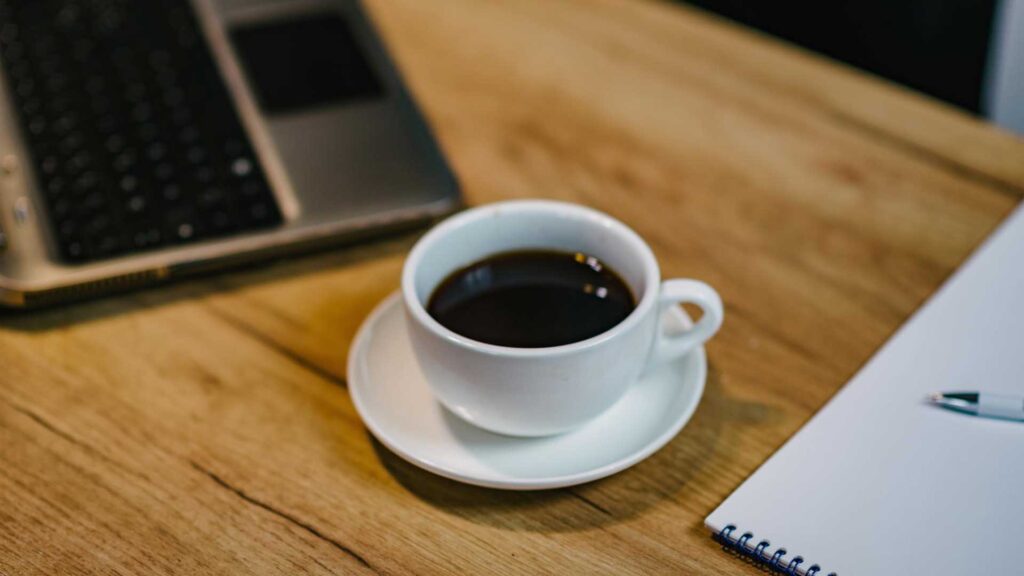 Black coffee sitting out in a room temperature.