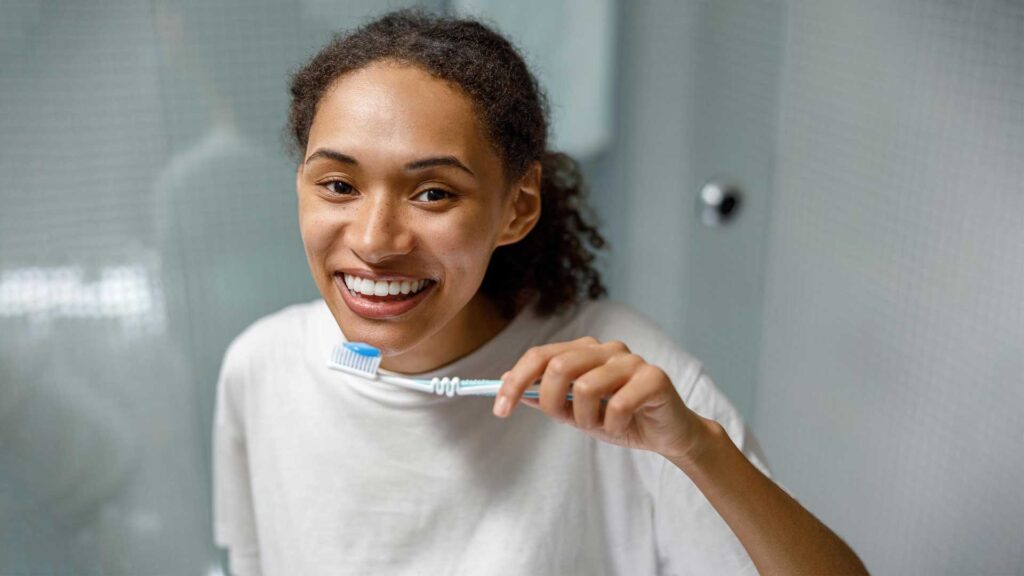 Brush twice a day to remove coffee stains from teeth naturally.