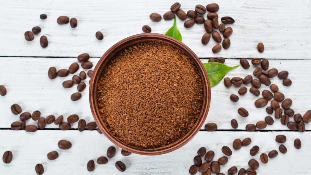Using coffee grounds in garden to keep cats away.